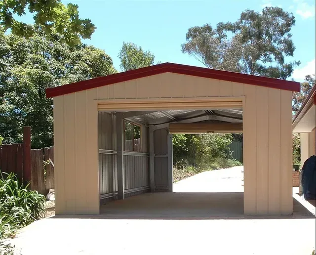Beige Metal Garage With Open Door, Red Trim, Concrete Driveway — Fair Dinkum Builds Port Stephens in Bobs Farm, NSW
