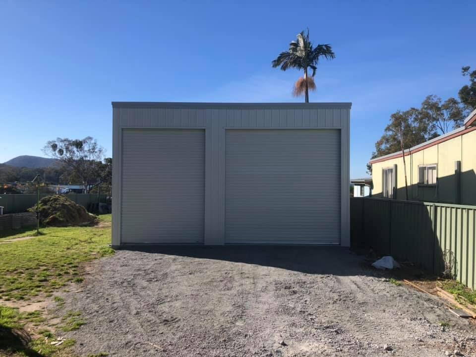 Gray Metal Shed with Two Roller Doors, Gravel Driveway — Fair Dinkum Builds Port Stephens in New Castle, NSW