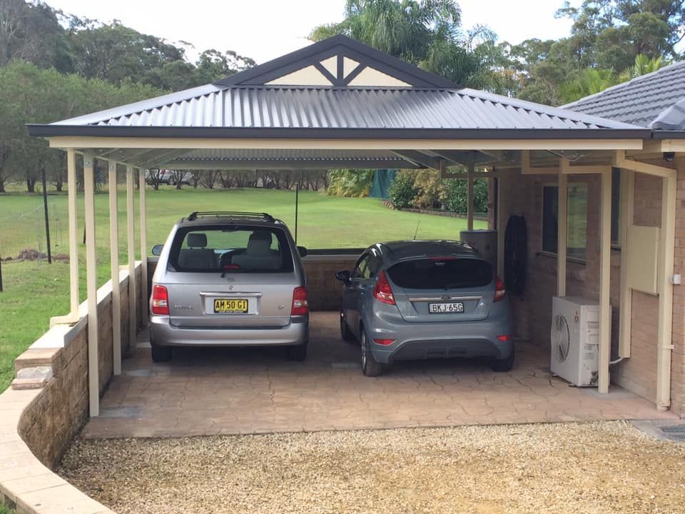 Black Roll-Up Garage Door in A Tan Metal Building — Fair Dinkum Builds Port Stephens in Hunter Valley, NSW