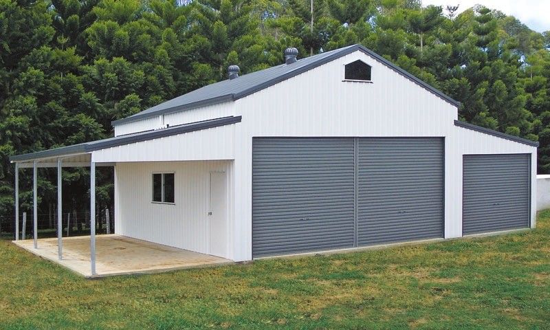 Metal garage with three dark gray doors under a blue sky.