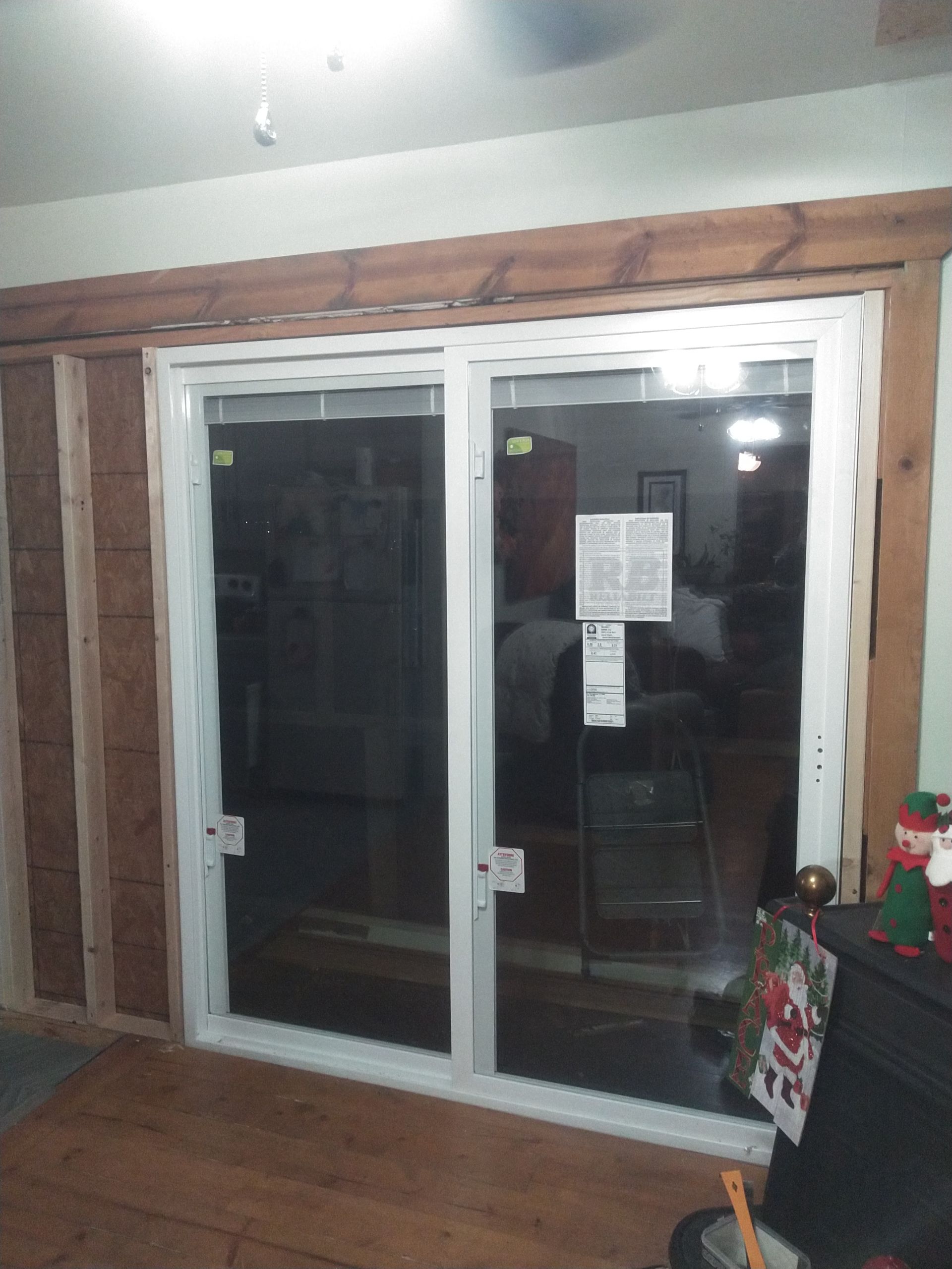 A living room with a sliding glass door that says lg on it