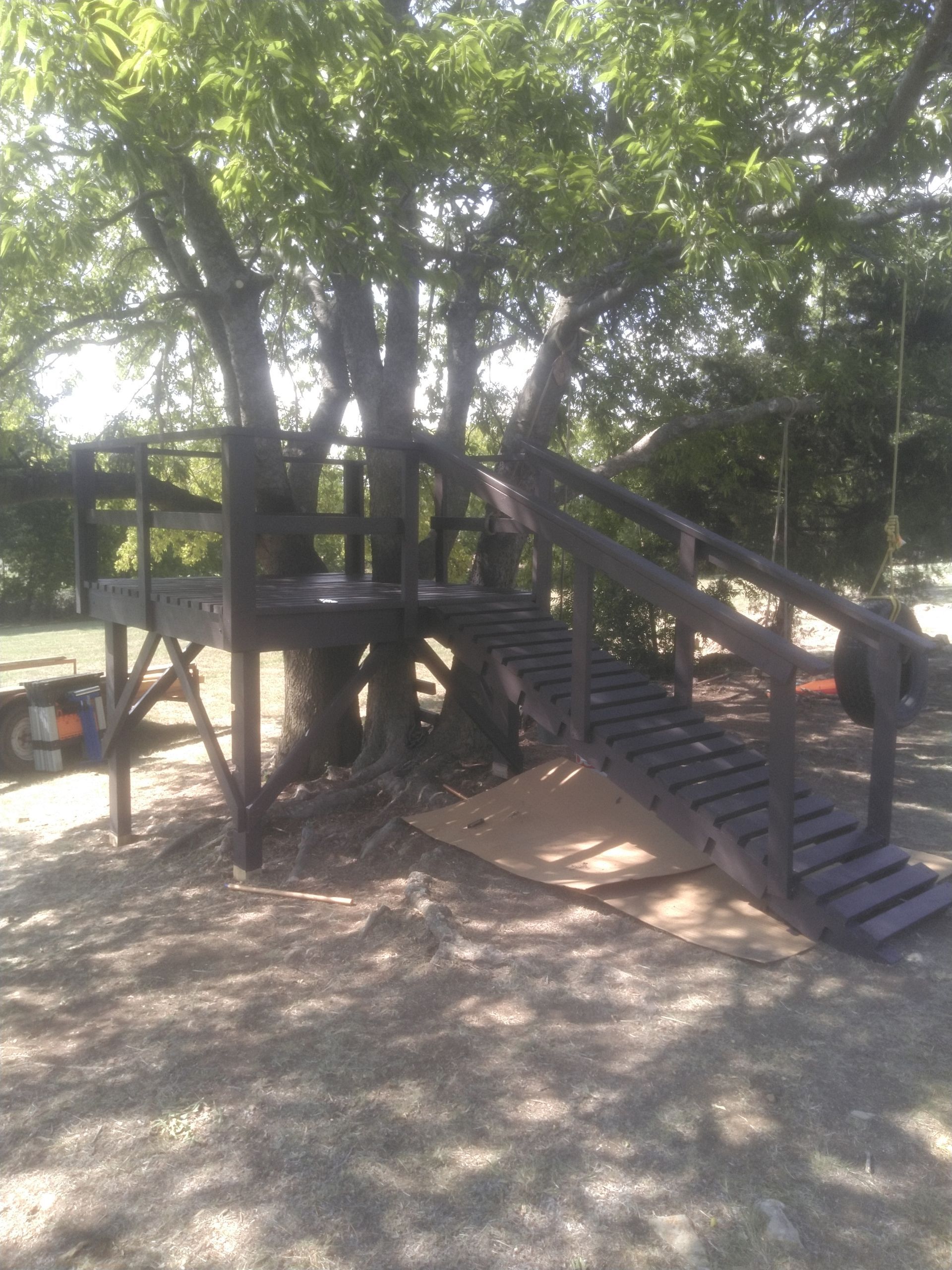 A tree house with stairs leading up to it