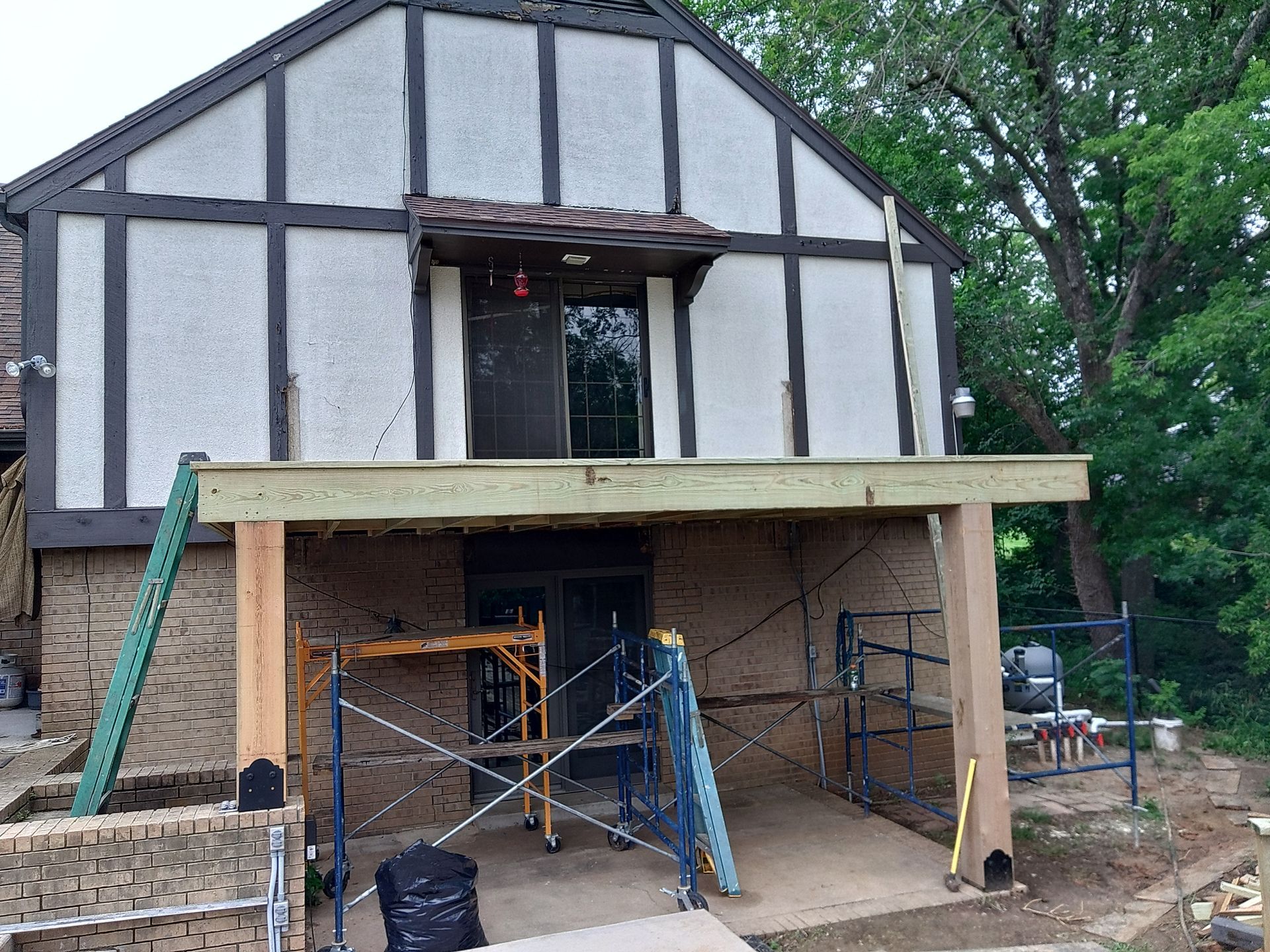 A house is being remodeled with a deck and scaffolding.