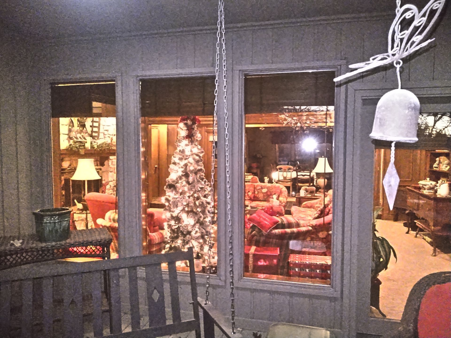 A christmas tree is lit up in a living room