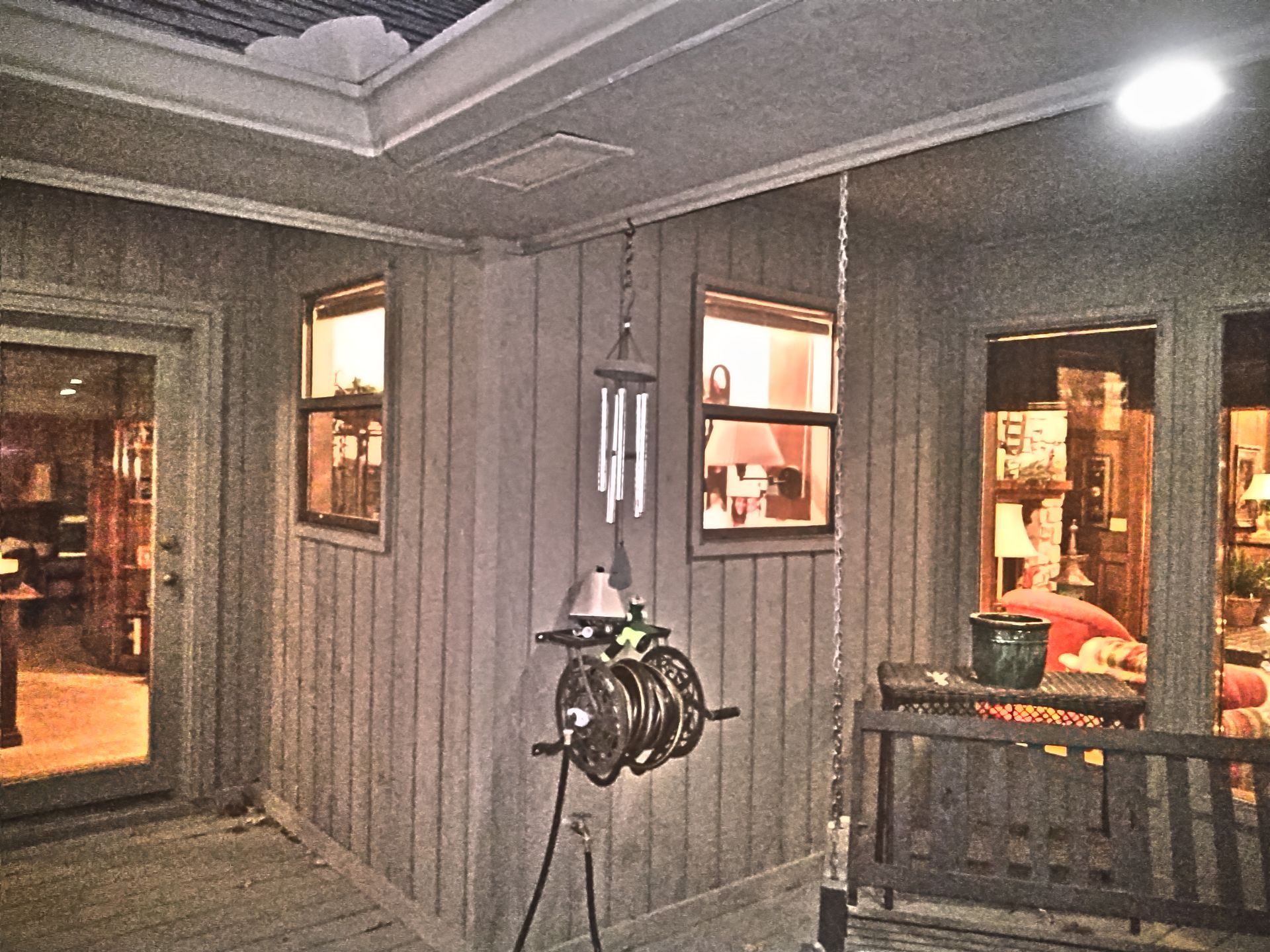 A wind chime is hanging on the side of a house