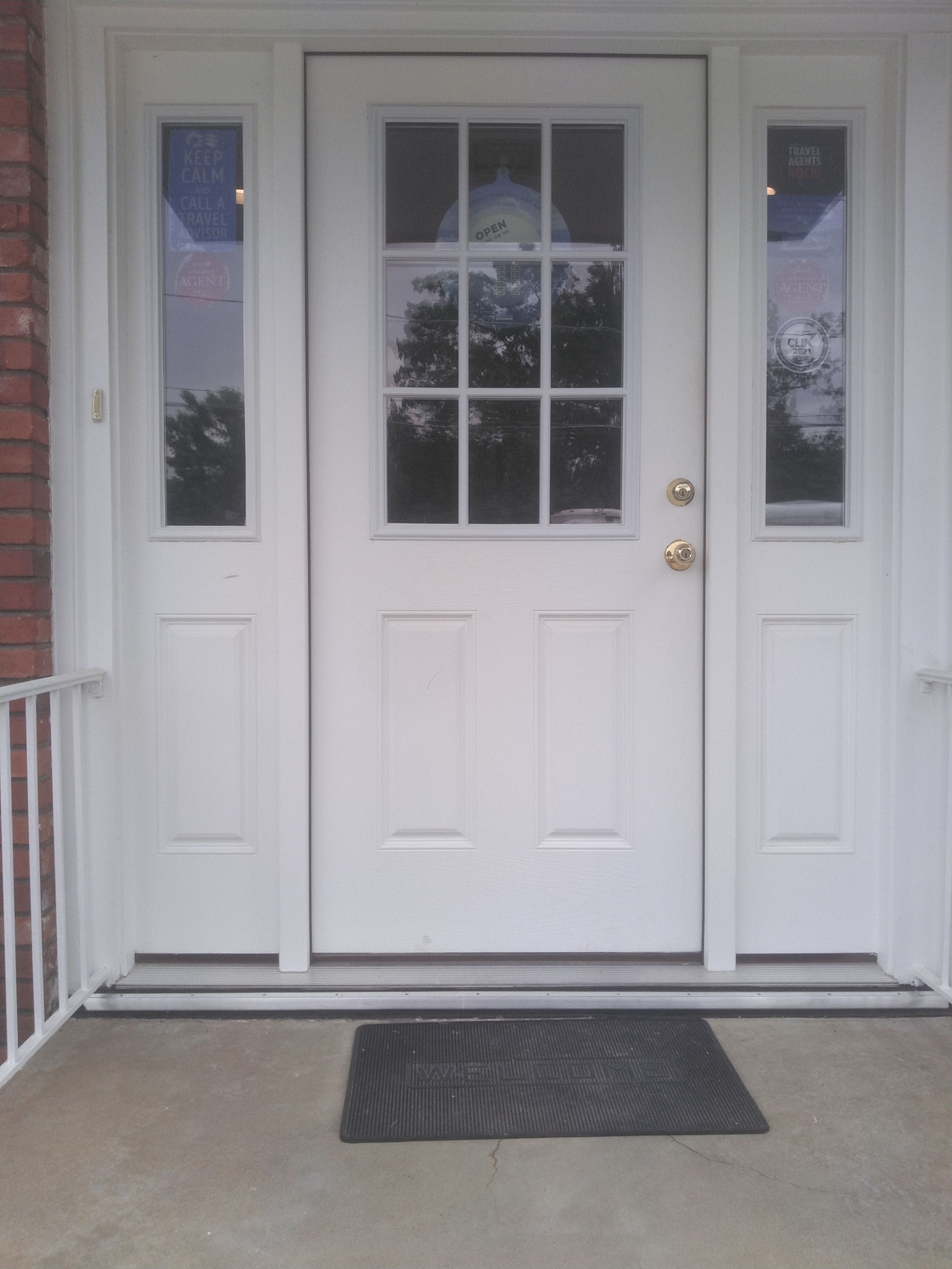 A white door with a black mat in front of it