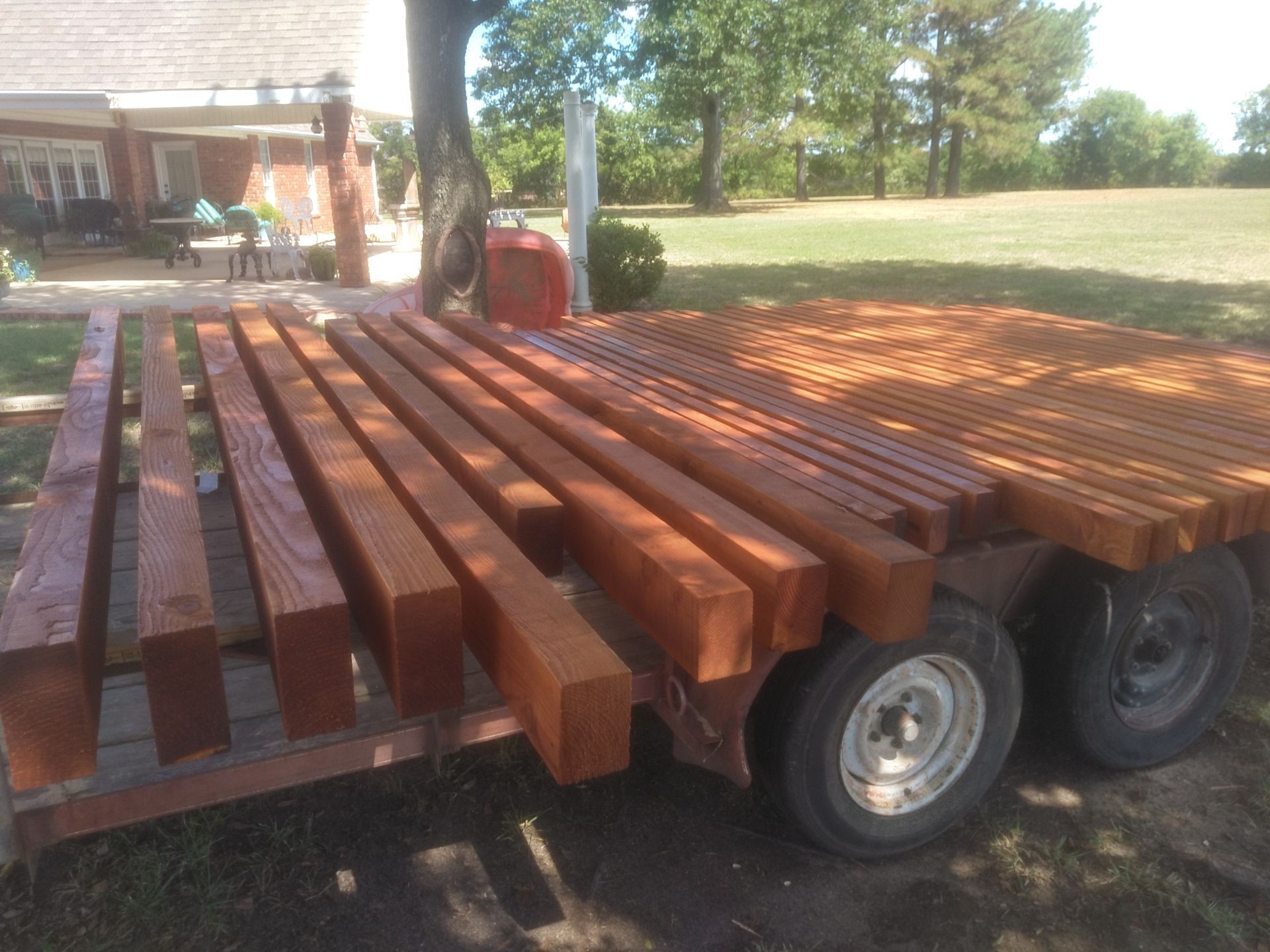 A trailer with a bunch of wooden beams on it