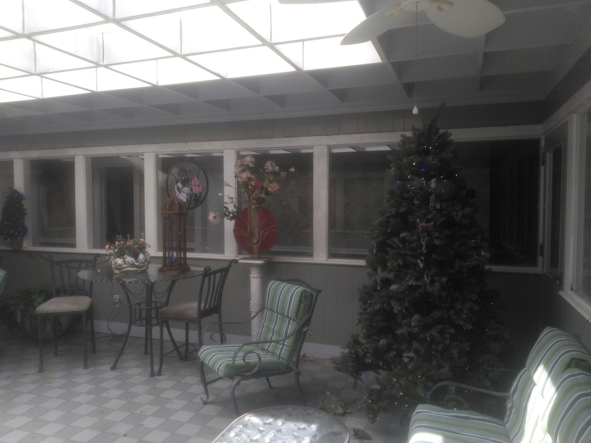 There is a christmas tree in the middle of the room