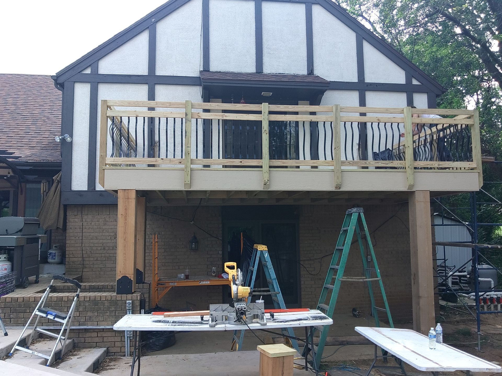 A wooden deck is being built on the side of a house