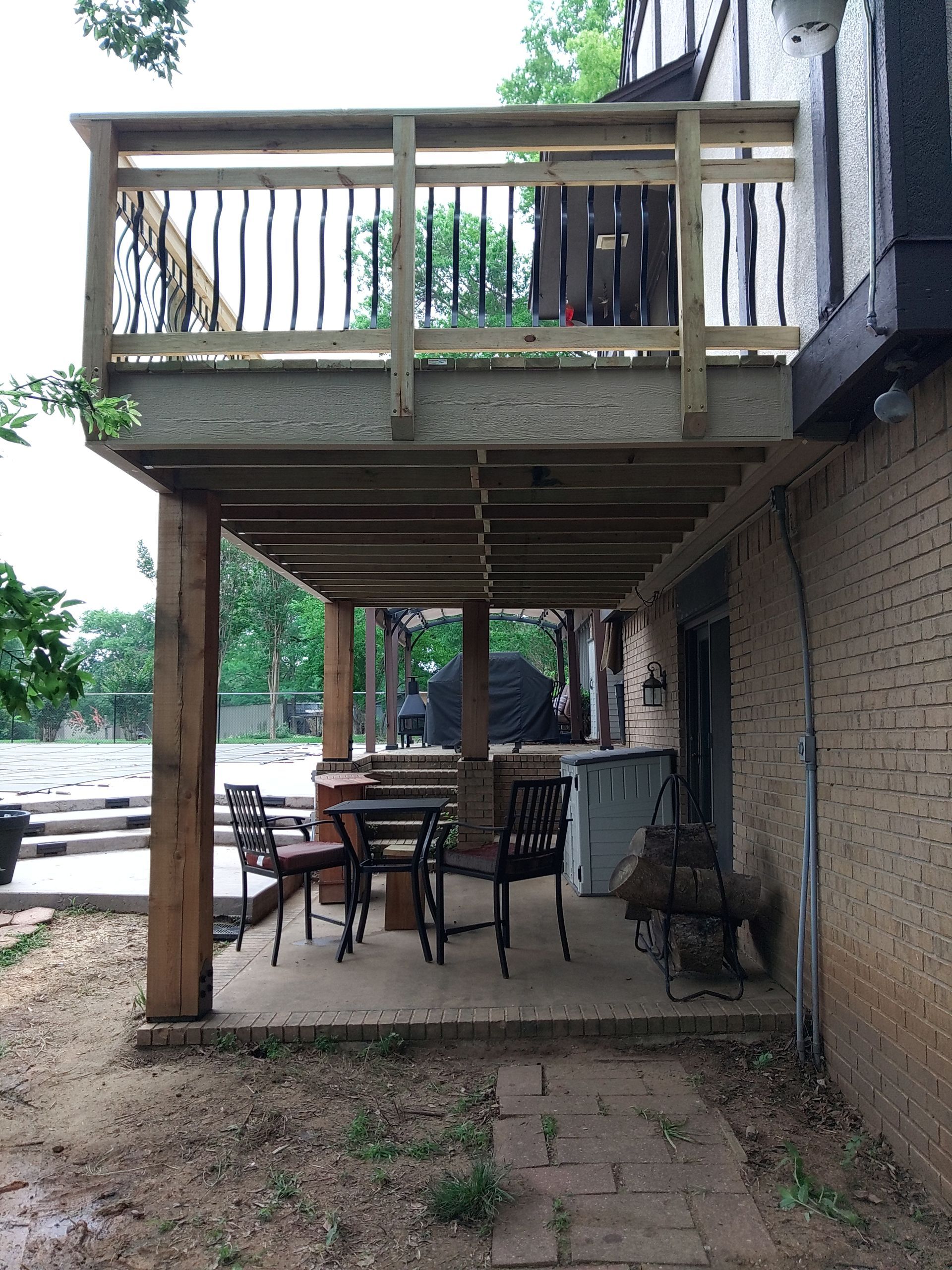 A wooden deck with a table and chairs on it