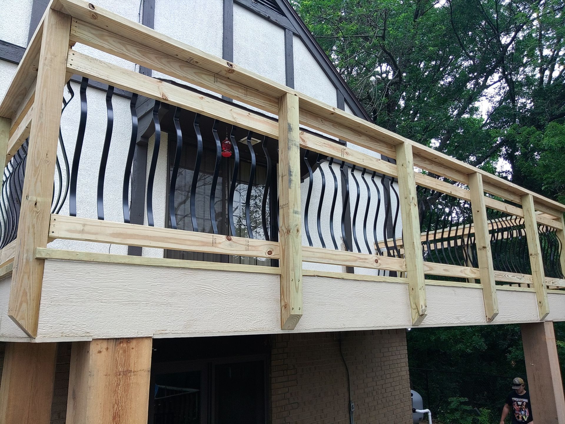 A wooden deck is being built on the side of a house