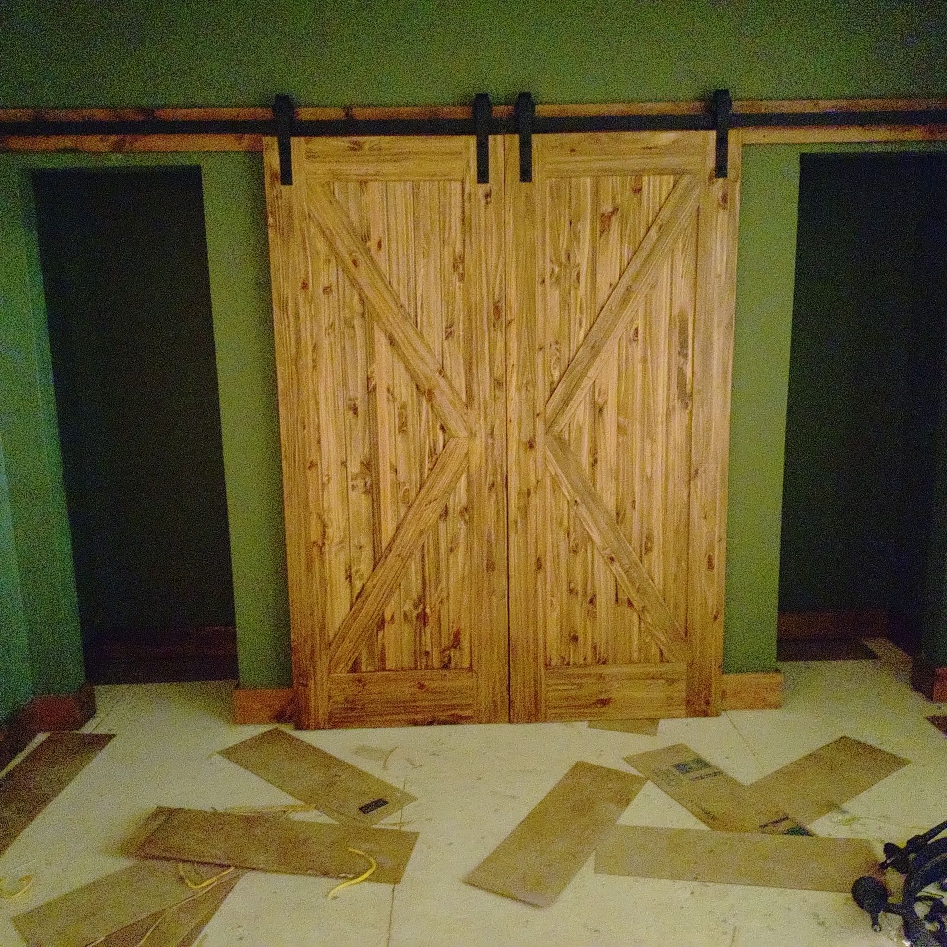 A pair of wooden sliding barn doors in a room