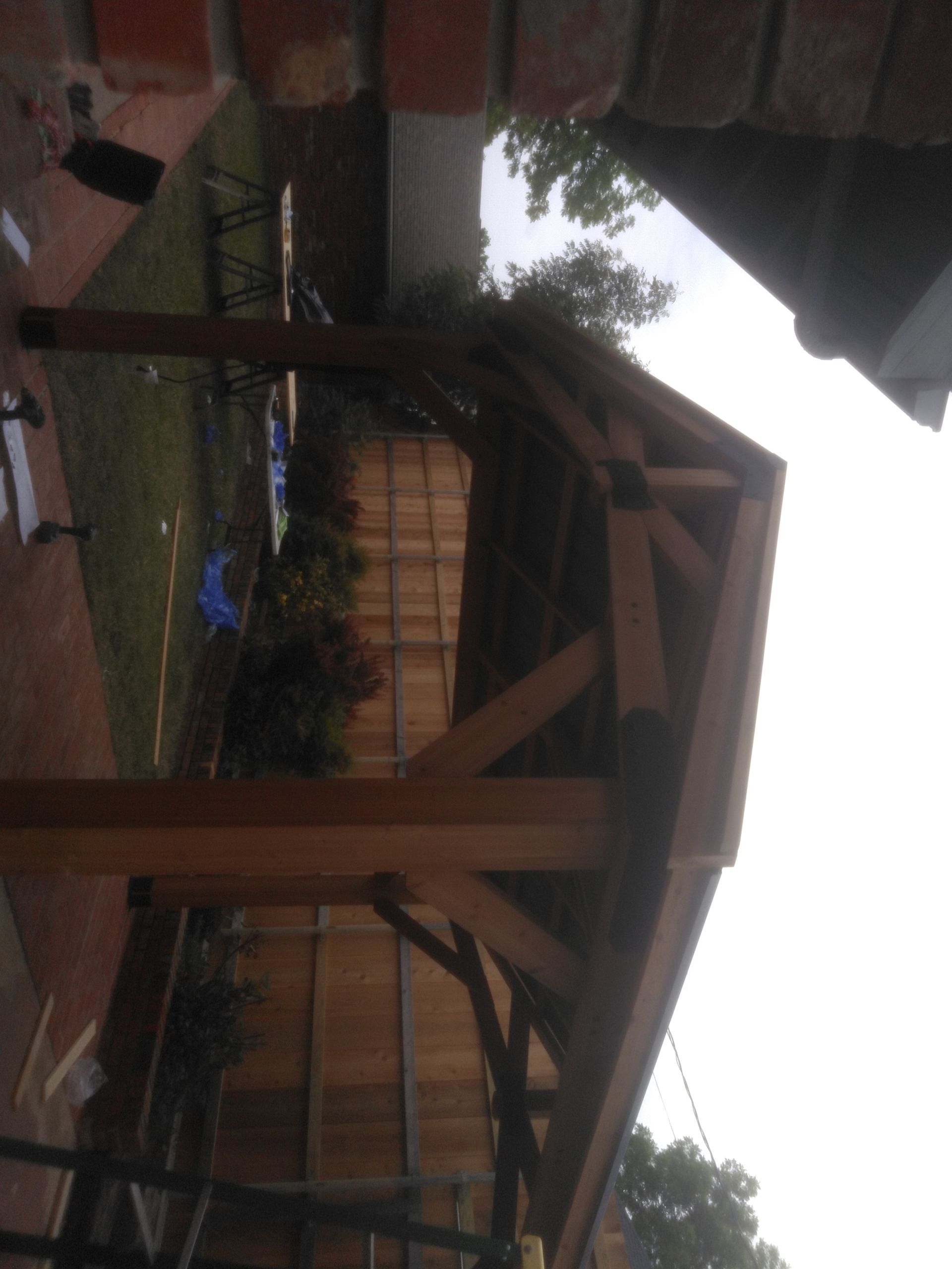 A wooden structure with a brick wall in the background