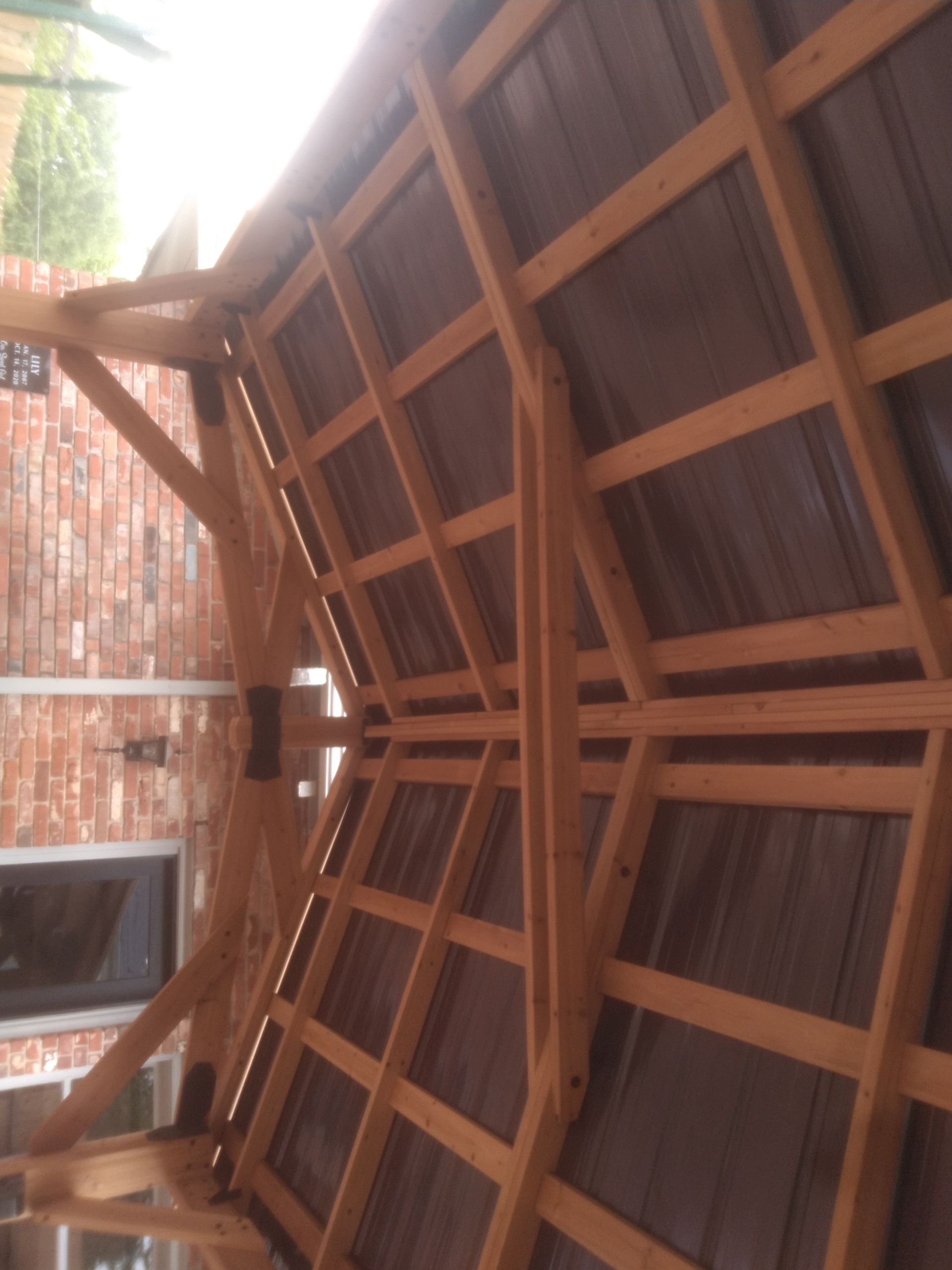 A wooden structure with a brick wall in the background