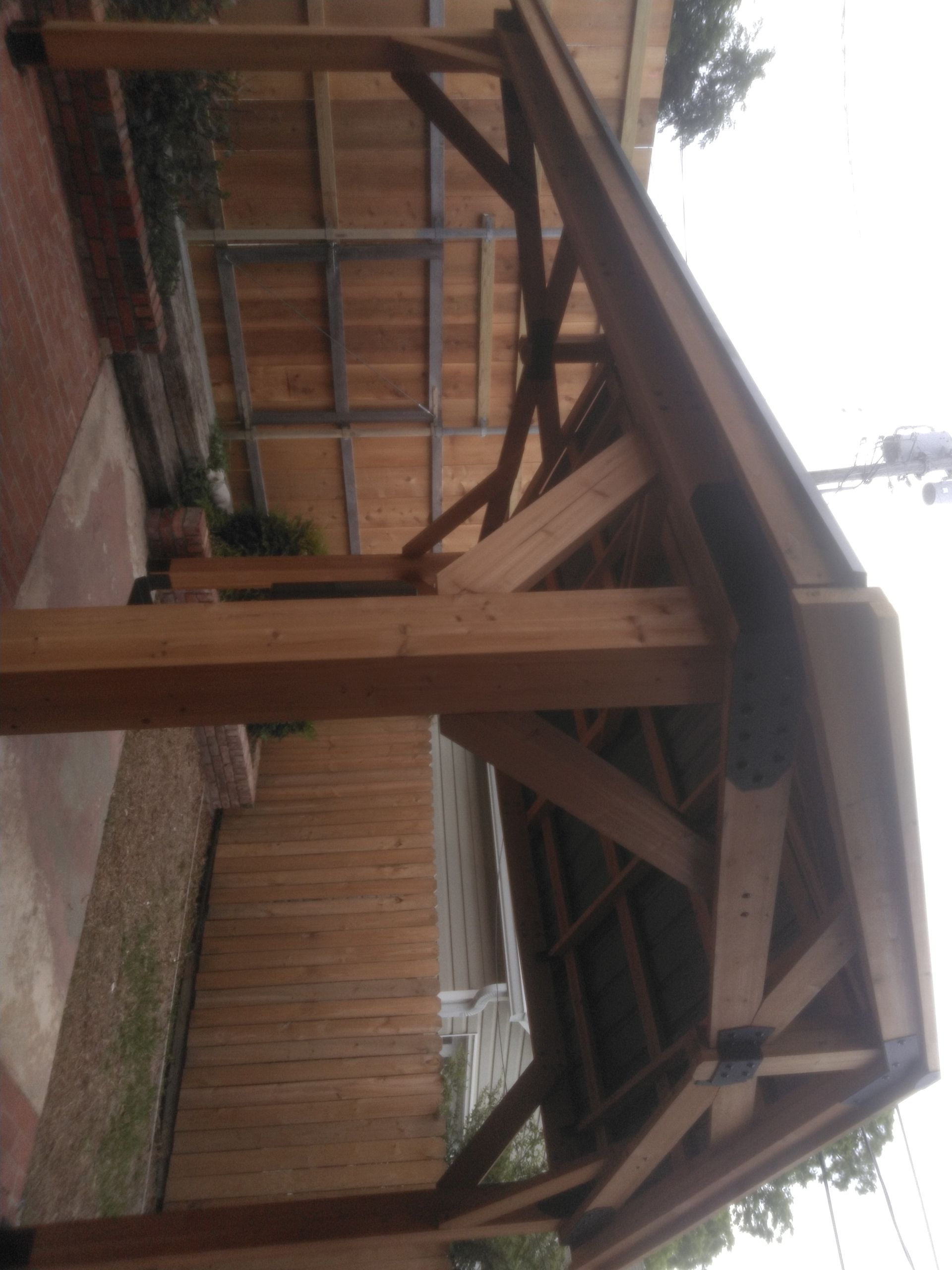 A wooden structure in front of a wooden fence