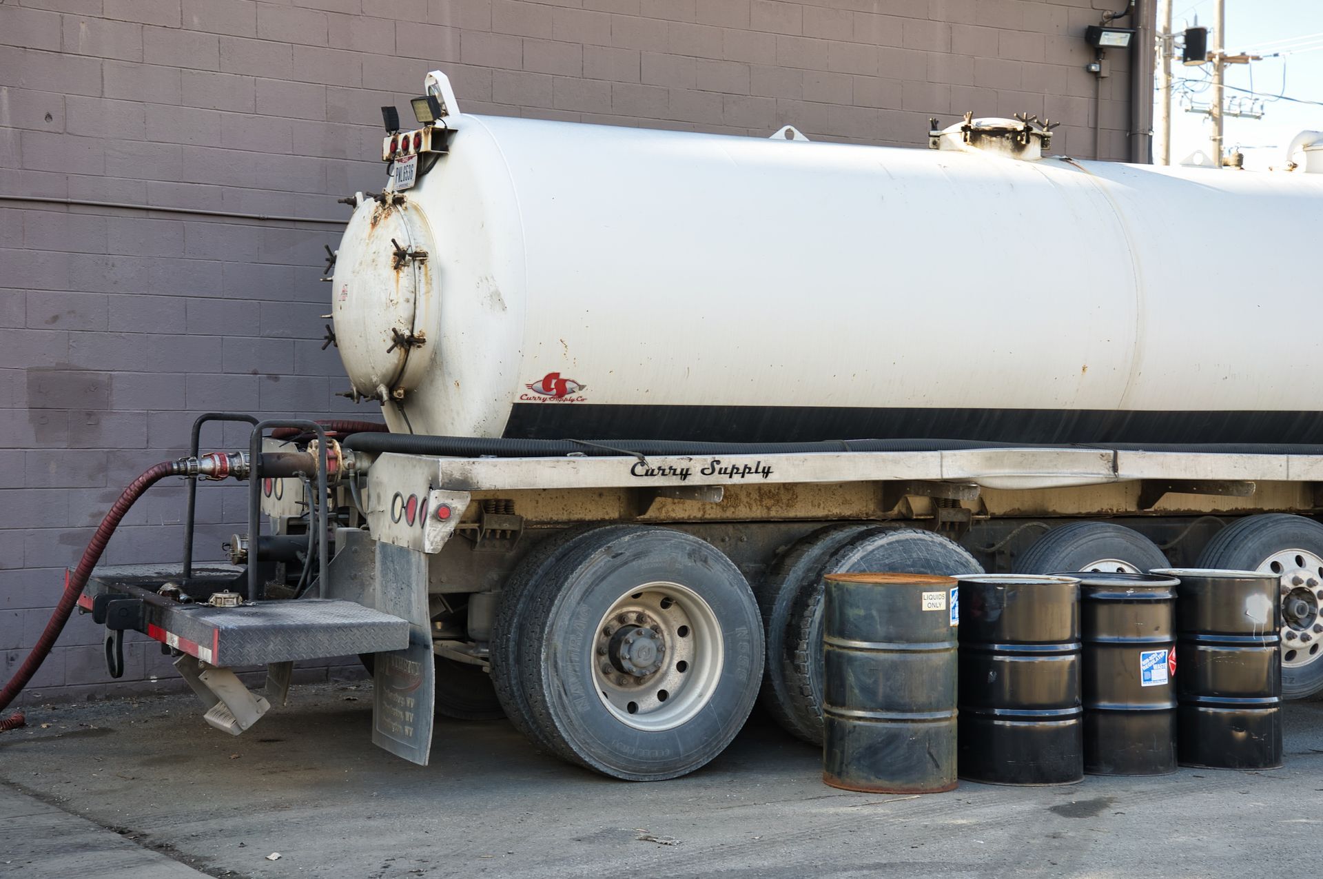 A tanker truck with a hose attached to it