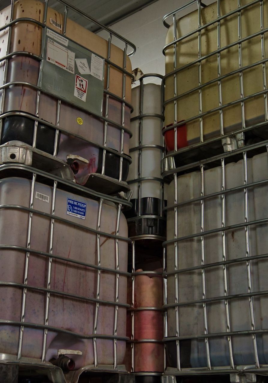 Several containers are stacked on top of each other and one of them has the number 555 on it