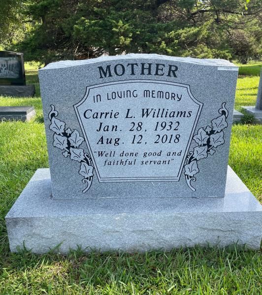 Gray gravestone in a grassy cemetery, inscribed “Mother” and “In loving memory” for Carrie L. Williams.