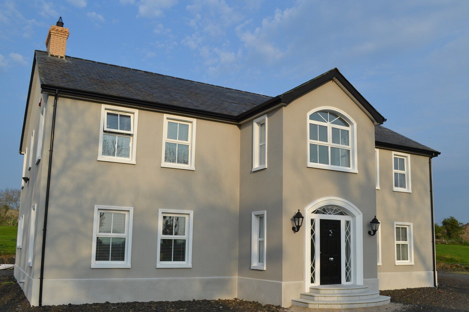 A large house with a gray roof and white windows