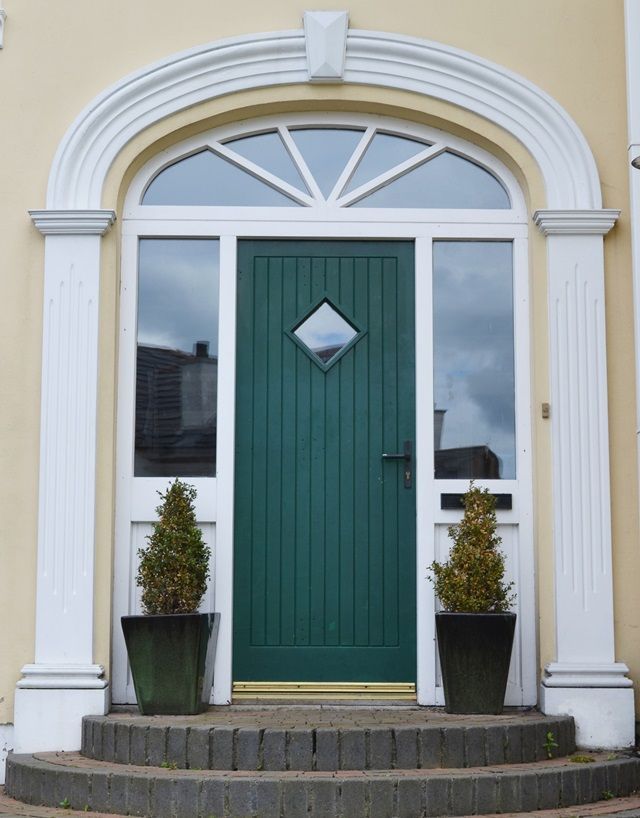 The front door of a house with a green door
