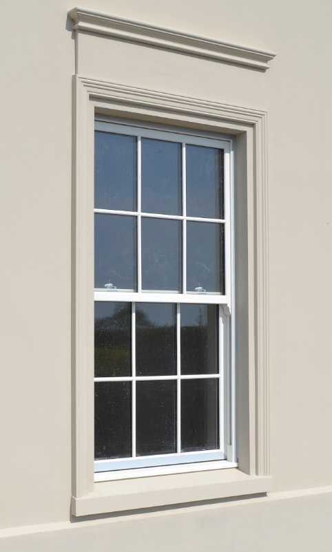 A window with a white frame on a white wall