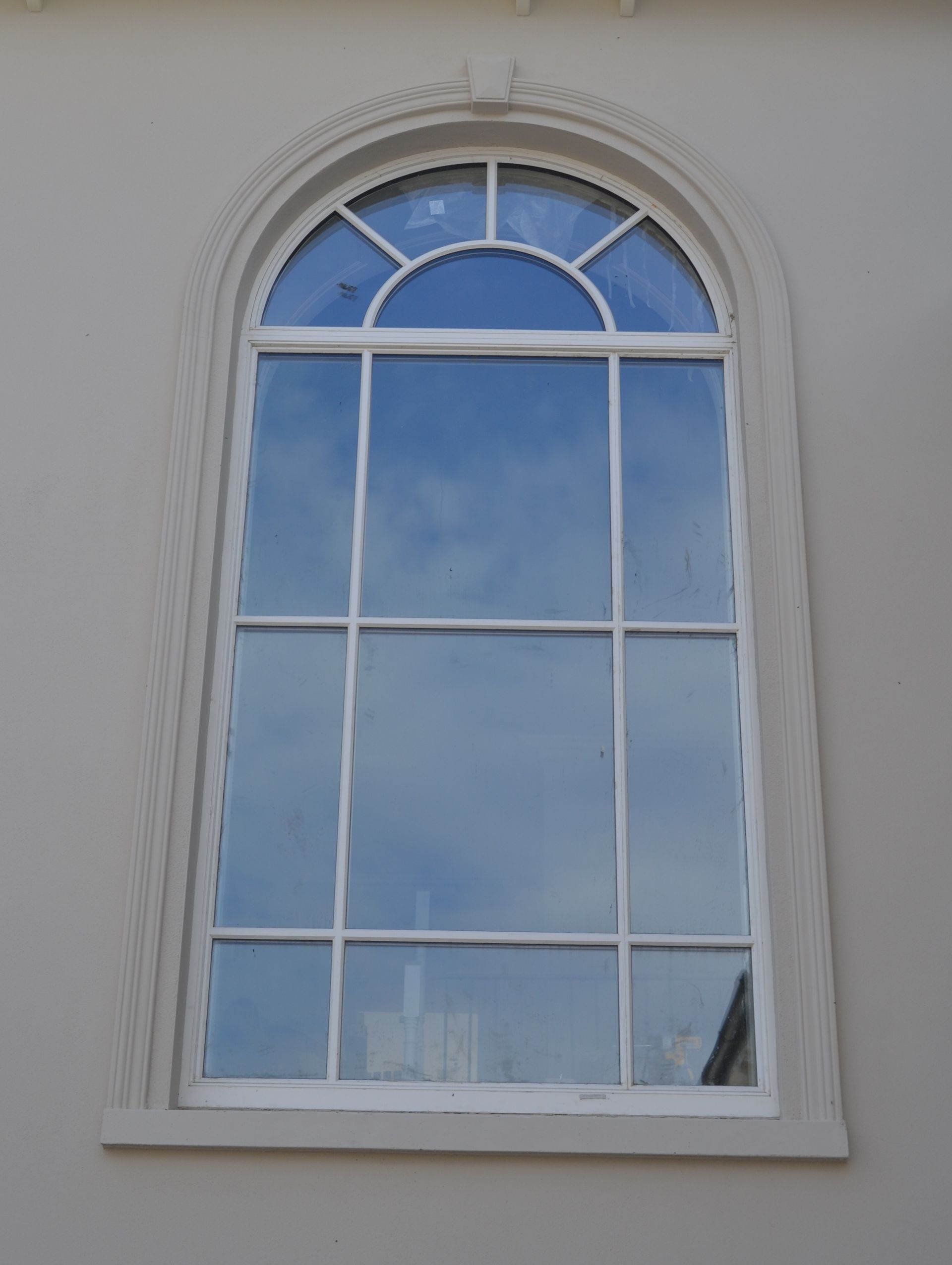 A white window with a blue sky reflected in it