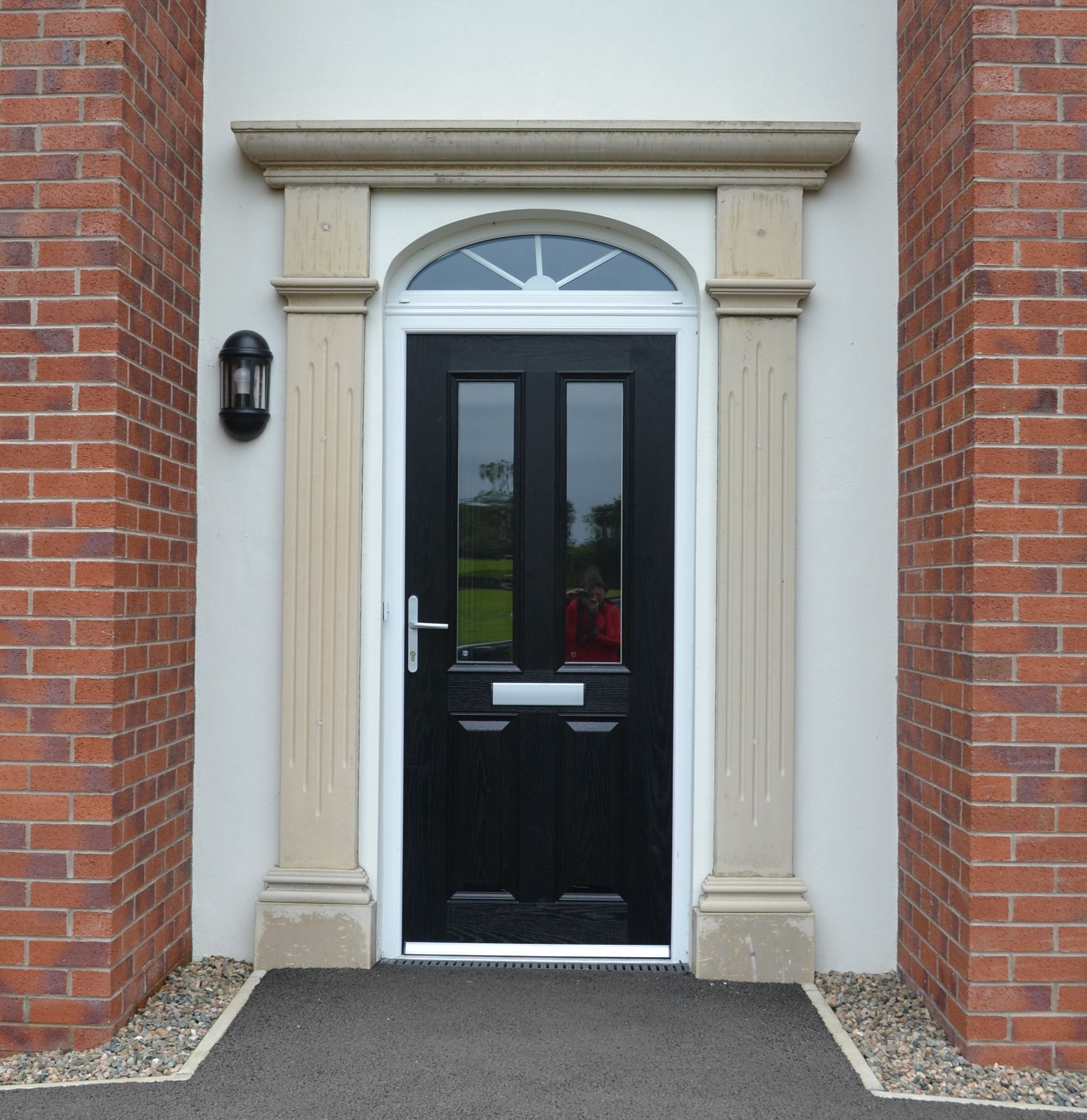 The front door of a brick building with a black door