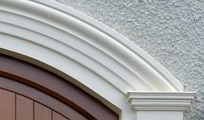 A close up of a door with a white molding on it.