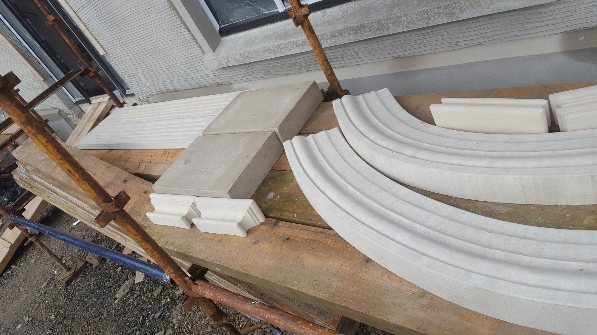 A wooden table with a bunch of pieces of concrete on it.