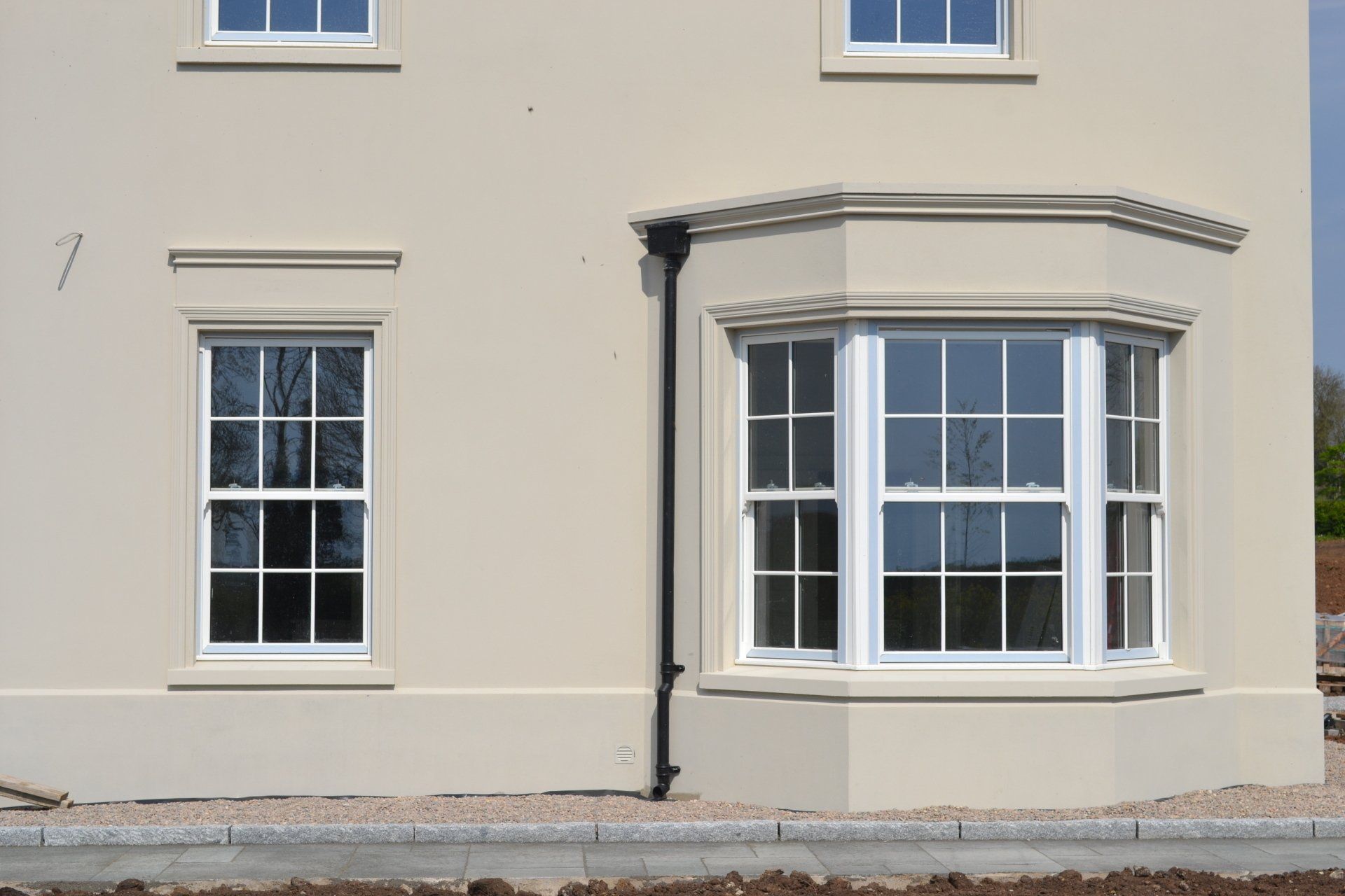 A house with a large bay window on the side of it.