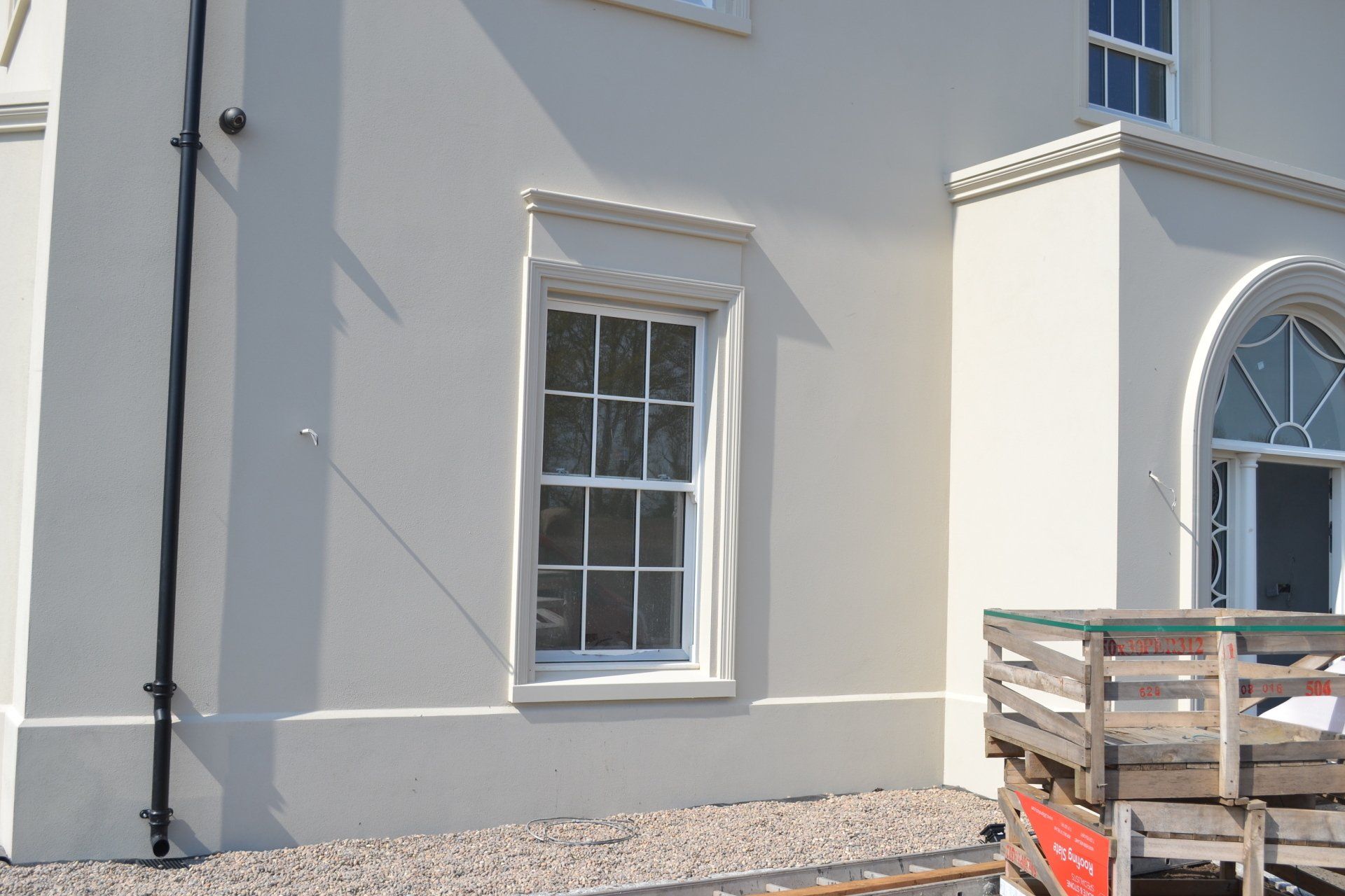 A white house with a wooden deck in front of it