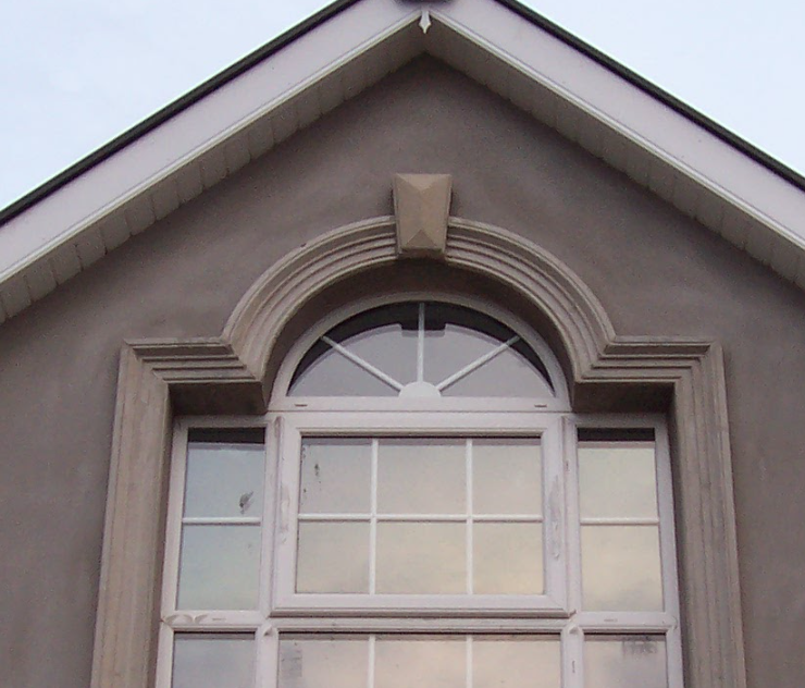 The roof of a house with a large window