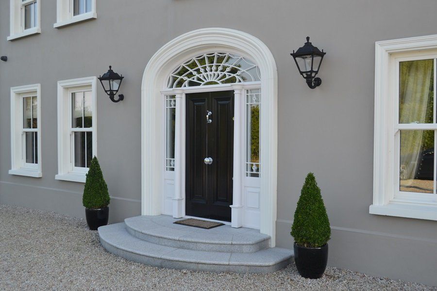 A large house with a black door and white trim