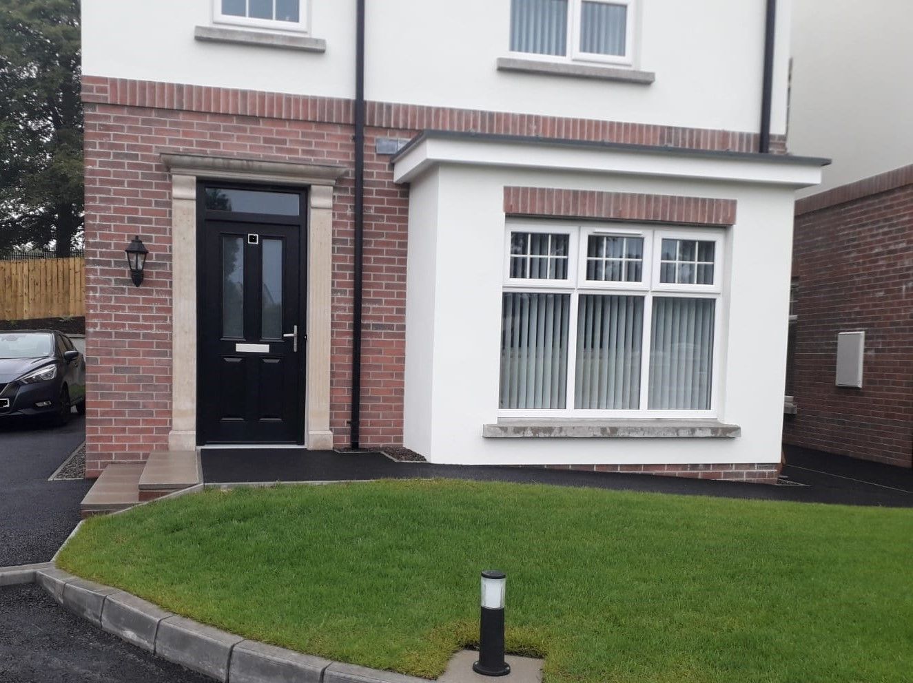 A white house with a black door and windows