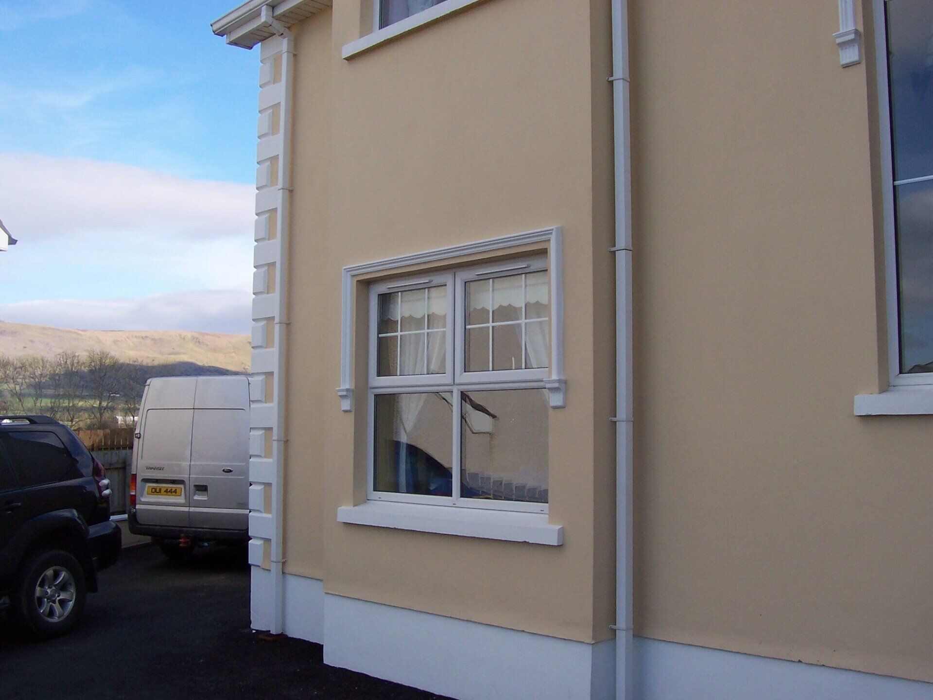 A house with a white van parked in front of it