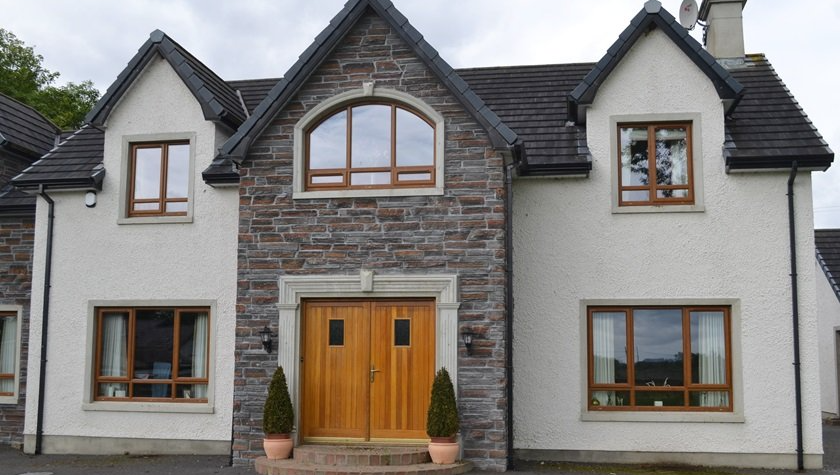 A large white house with a wooden door and windows