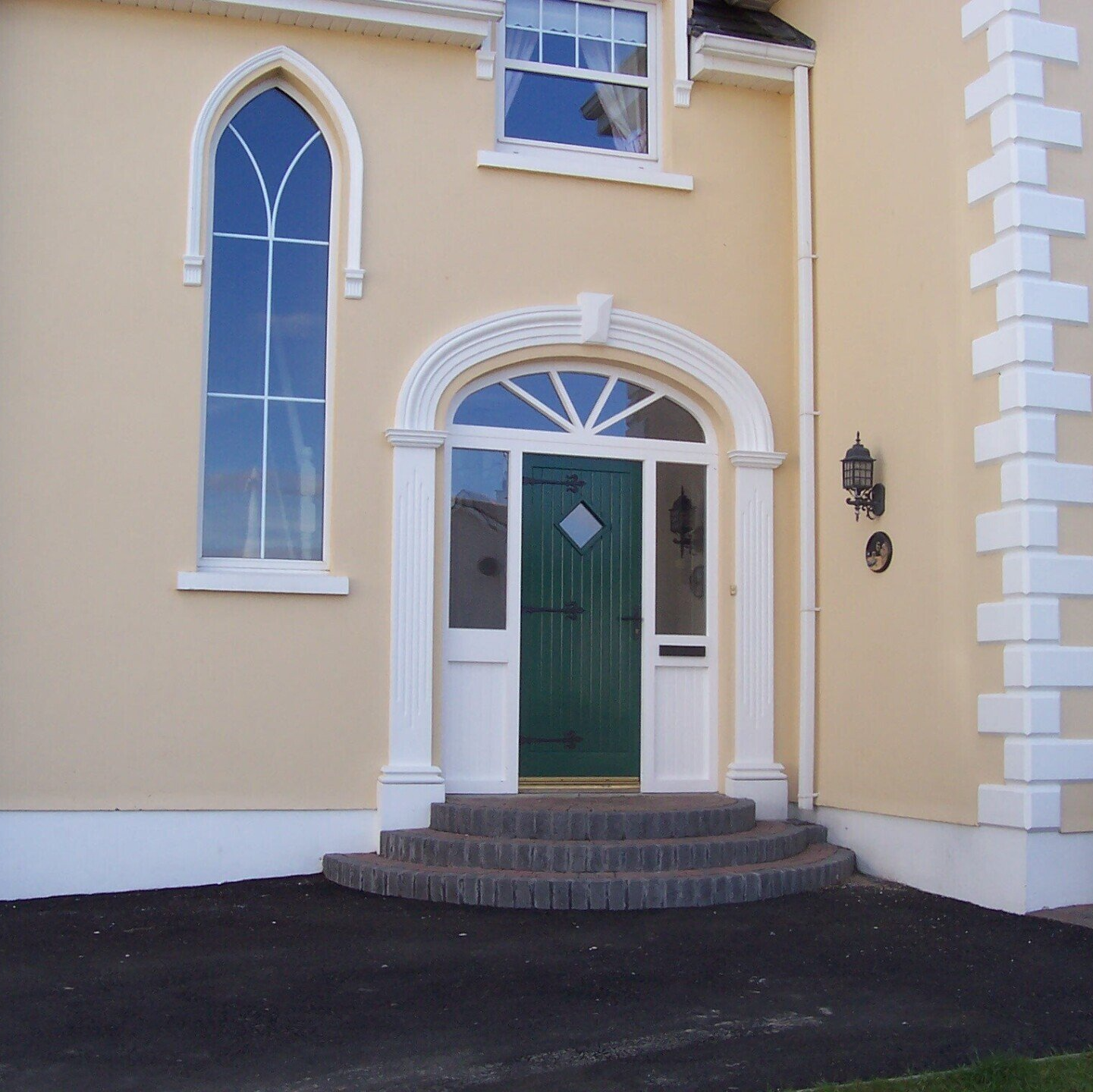 A house with a green door and white trim
