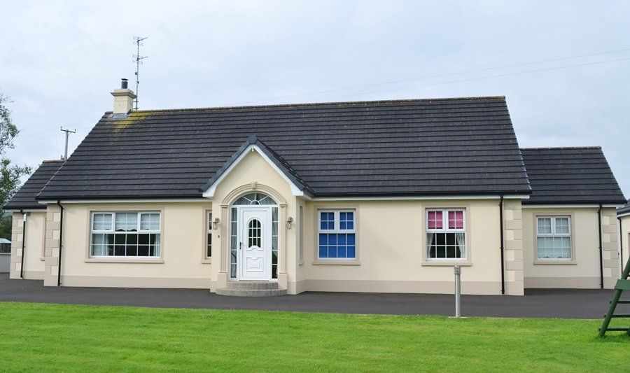 A house with a black roof and a white door