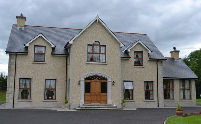 A large house with a driveway in front of it
