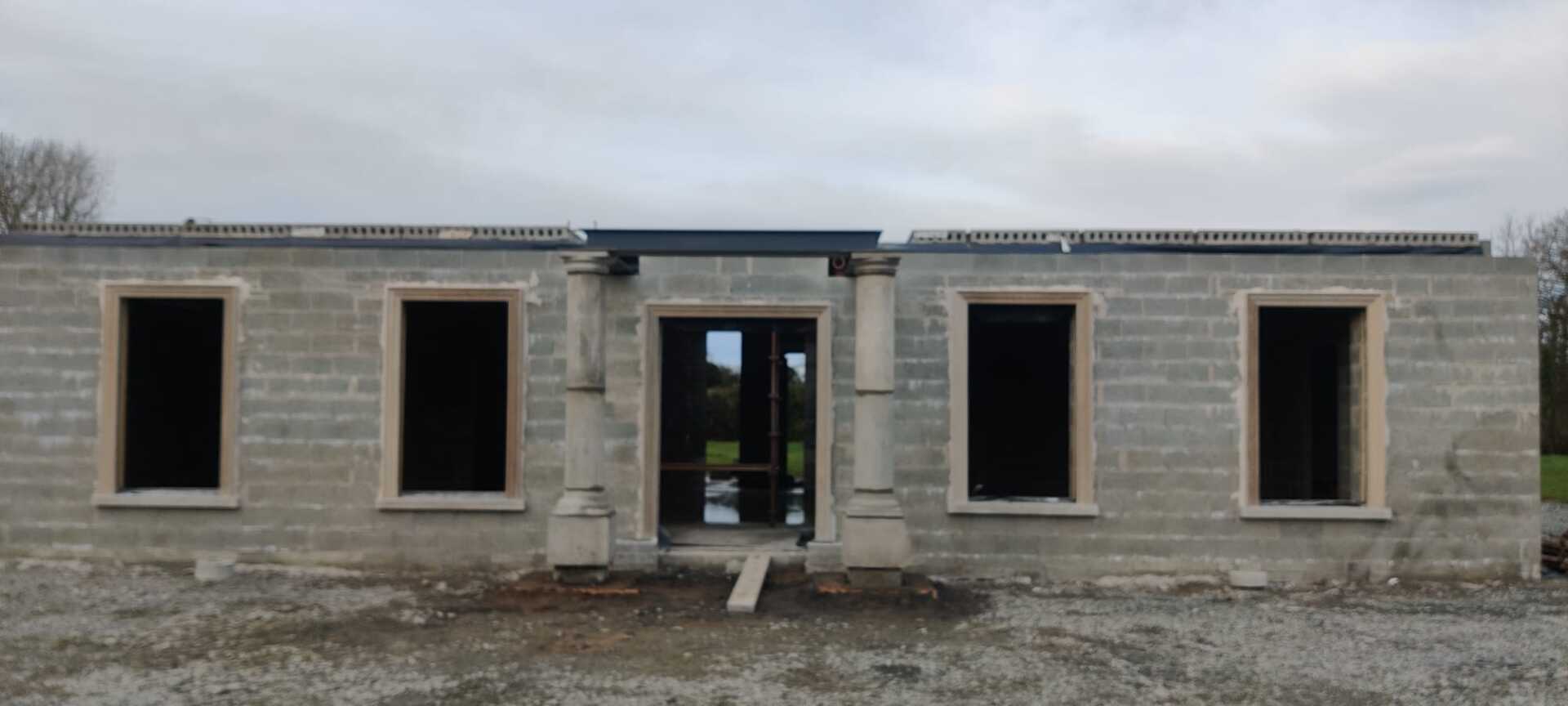 A brick building under construction with a lot of windows