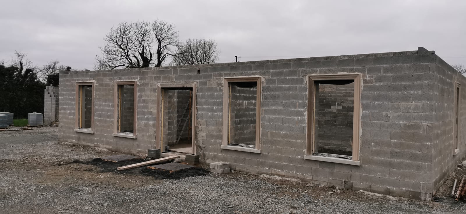 A brick building with a lot of windows is being built.