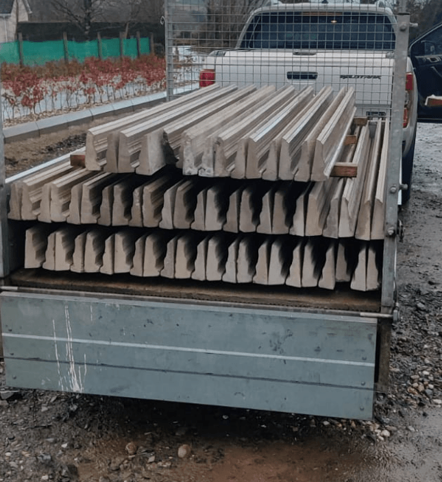 A truck with a stack of concrete blocks in the back