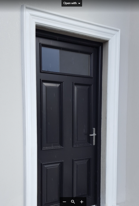 A black door with a white trim and a window