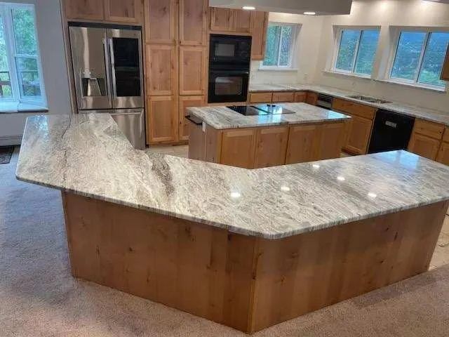 There is a large island in the middle of the kitchen.