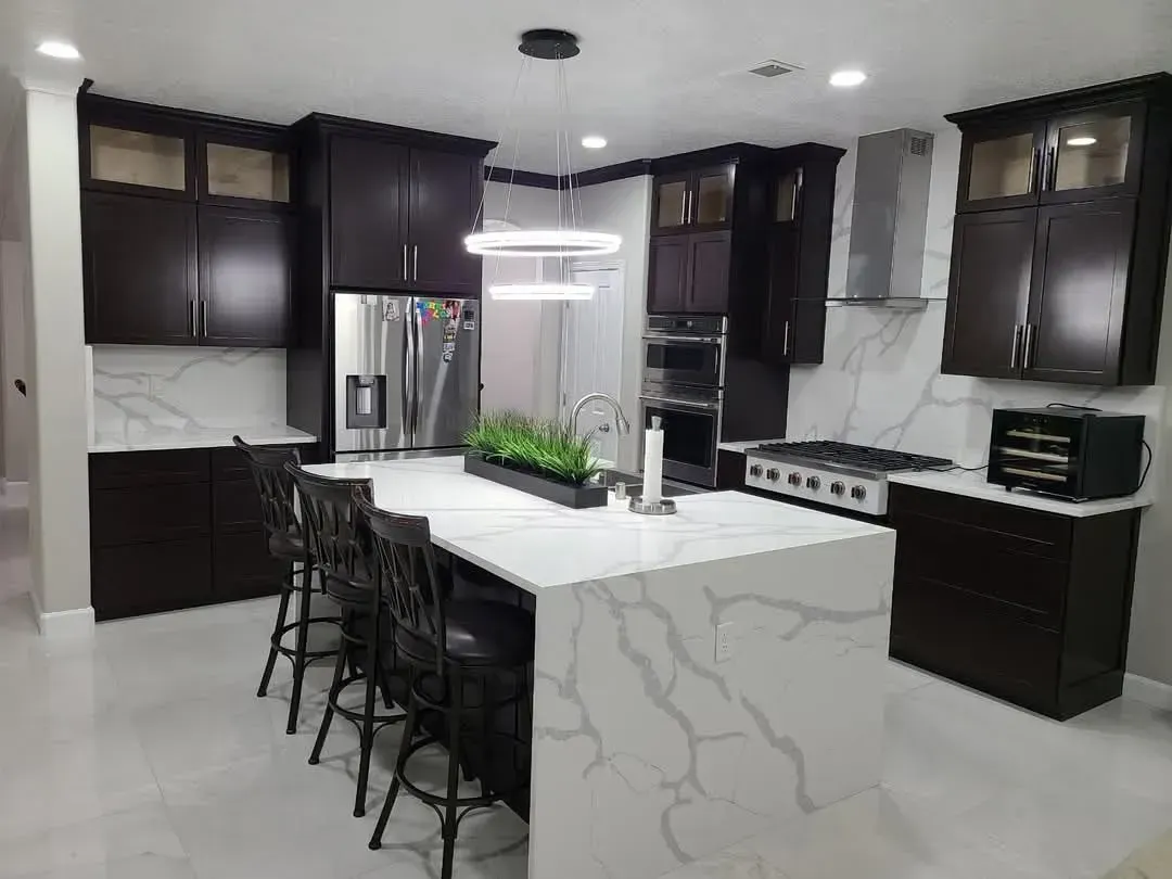 There is a large island in the middle of the kitchen.