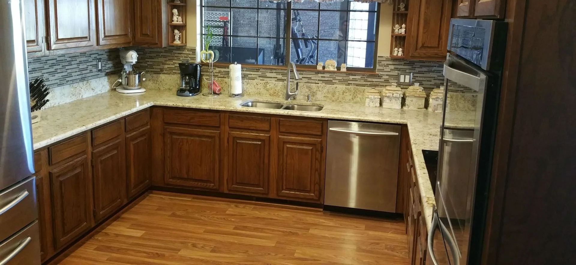A kitchen with stainless steel appliances and wooden cabinets.