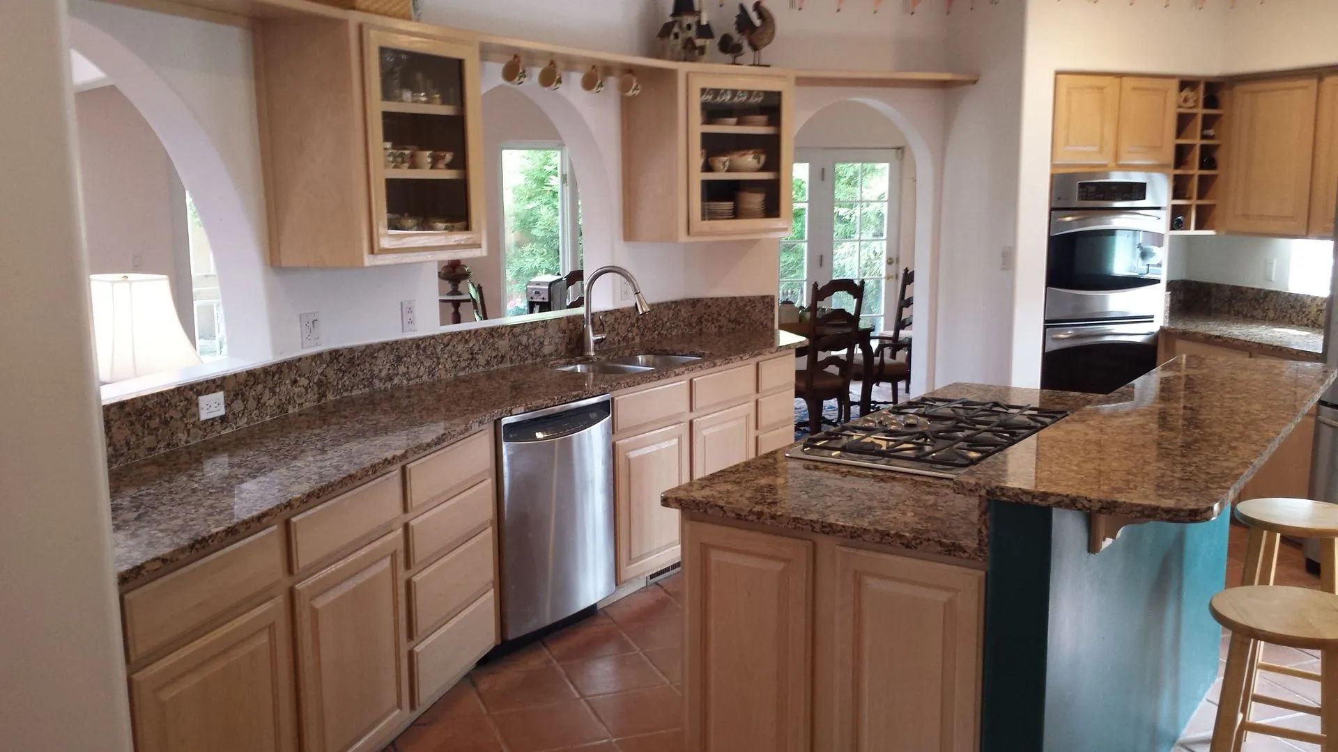A kitchen with granite counter tops and stainless steel appliances