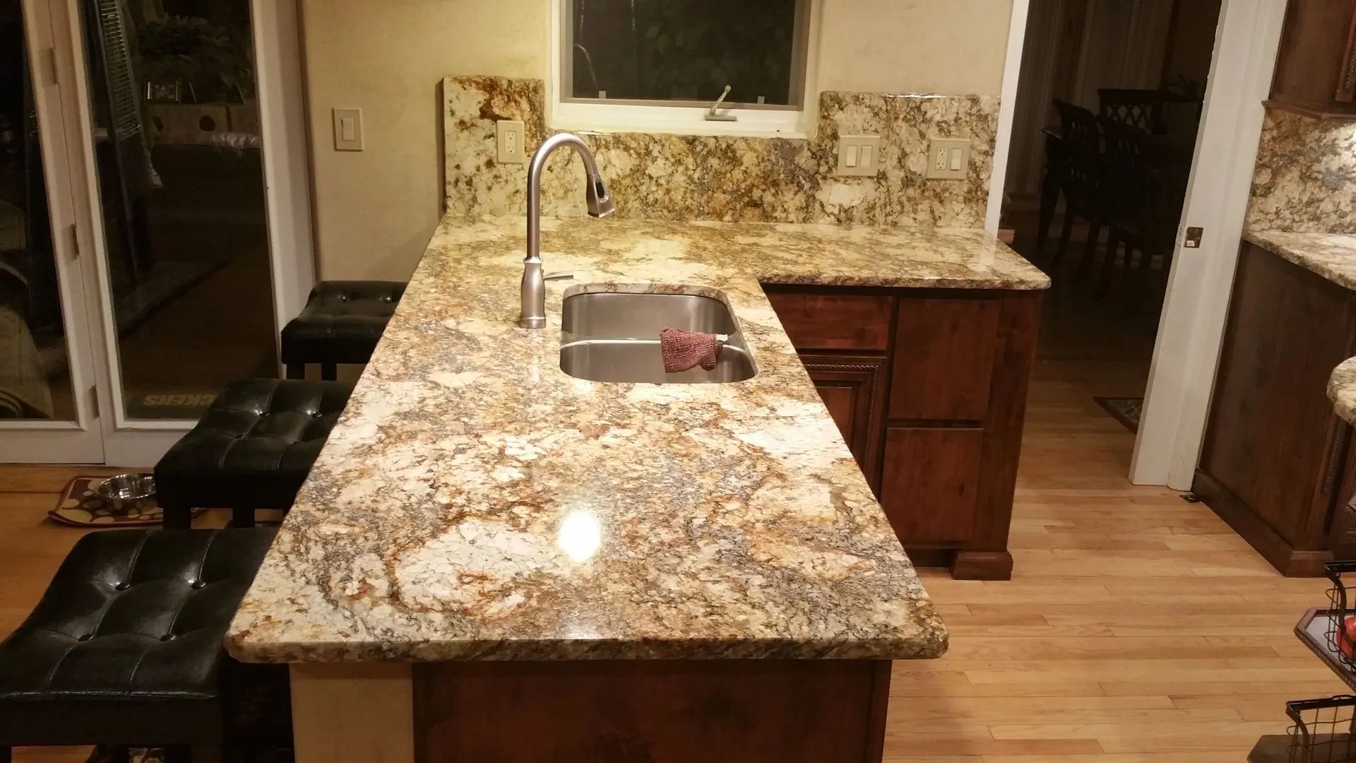 A kitchen with granite counter tops and a sink.