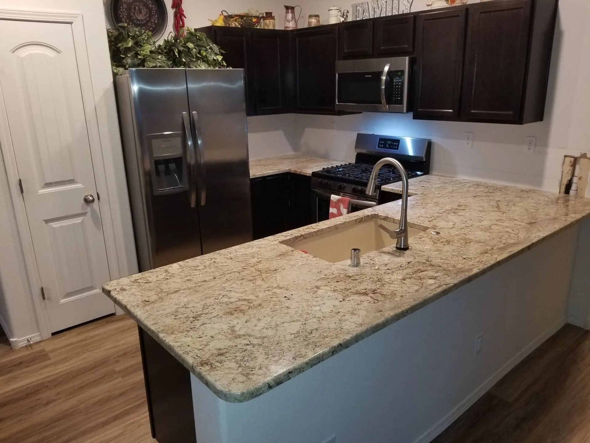 A kitchen with granite counter tops and stainless steel appliances