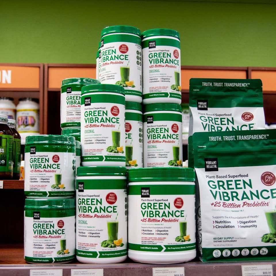 A variety of green vibrance products are stacked on a shelf